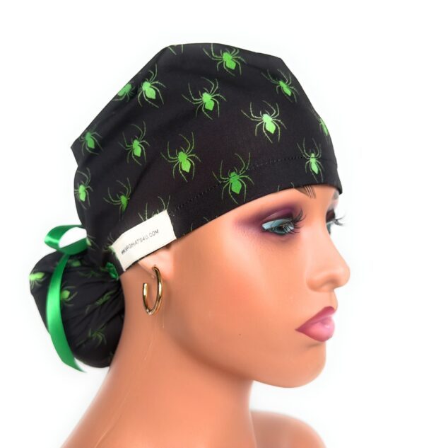 Glowing Spiders ponytail scrub cap with black and green spider print